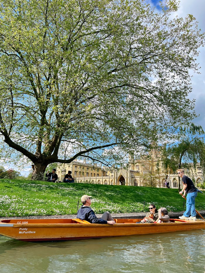 who-we-are Tranquil scenery of punting on River Cam near historic Cambridge landmarks.
